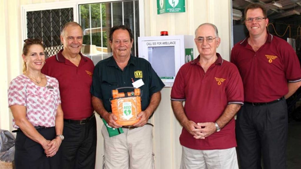 Community group holding a defibrillator
