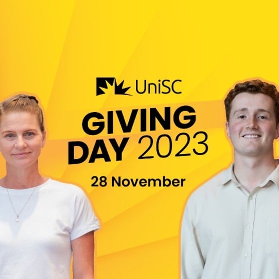 Two young people standing against a yellow background with UniSC Giving Day 2023 28 November written on it. 
